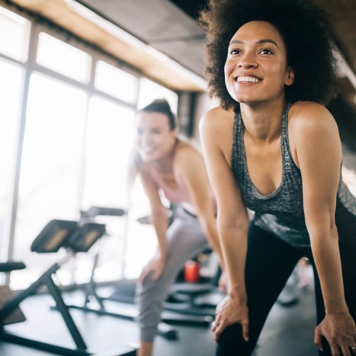 Fit sportswoman exercising and training in gym